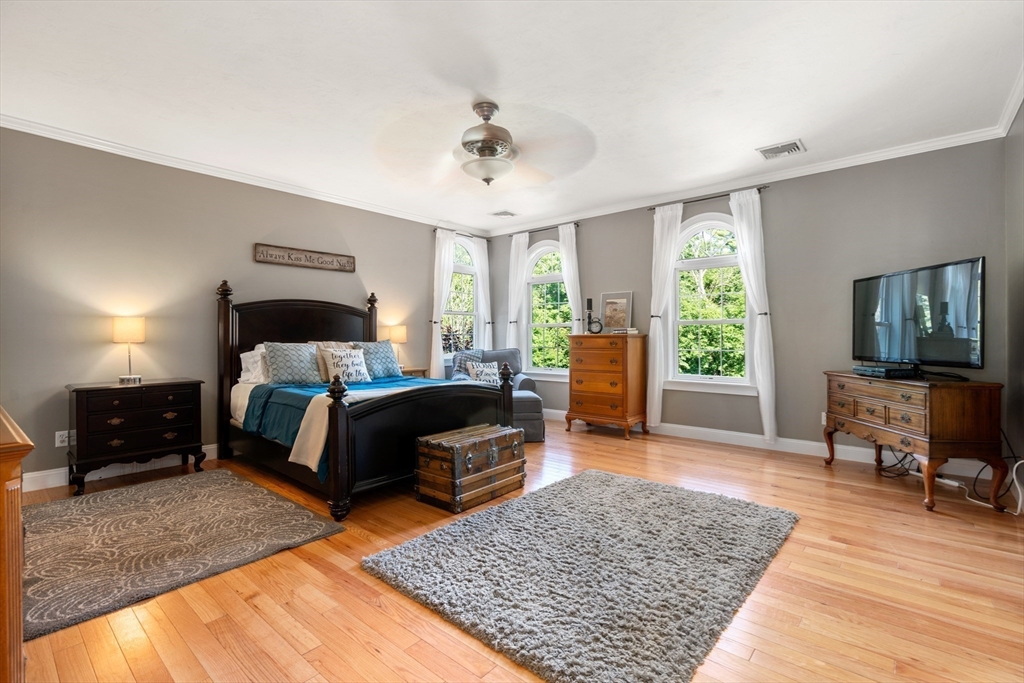400 New Boston Road Sturbridge, MA 01566 - Photo 27 of 42 a bedroom with a bed a couch and wooden floor