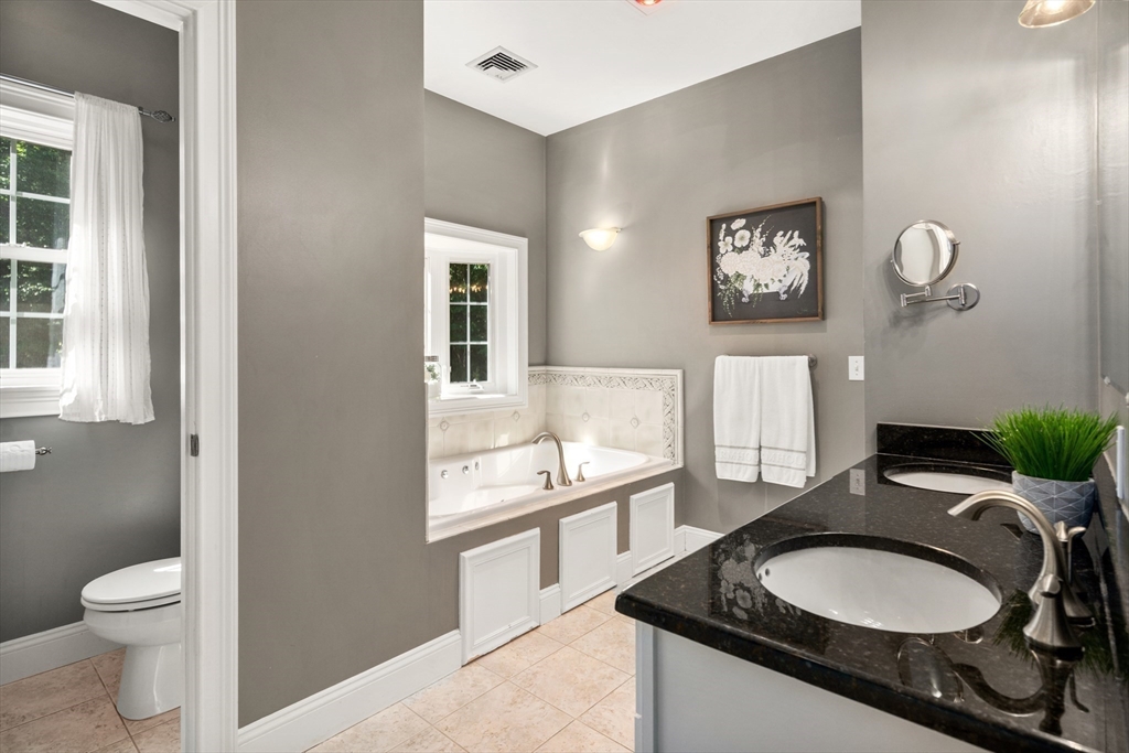 400 New Boston Road Sturbridge, MA 01566 - Photo 29 of 42 a bathroom with a granite countertop sink a toilet and a mirror