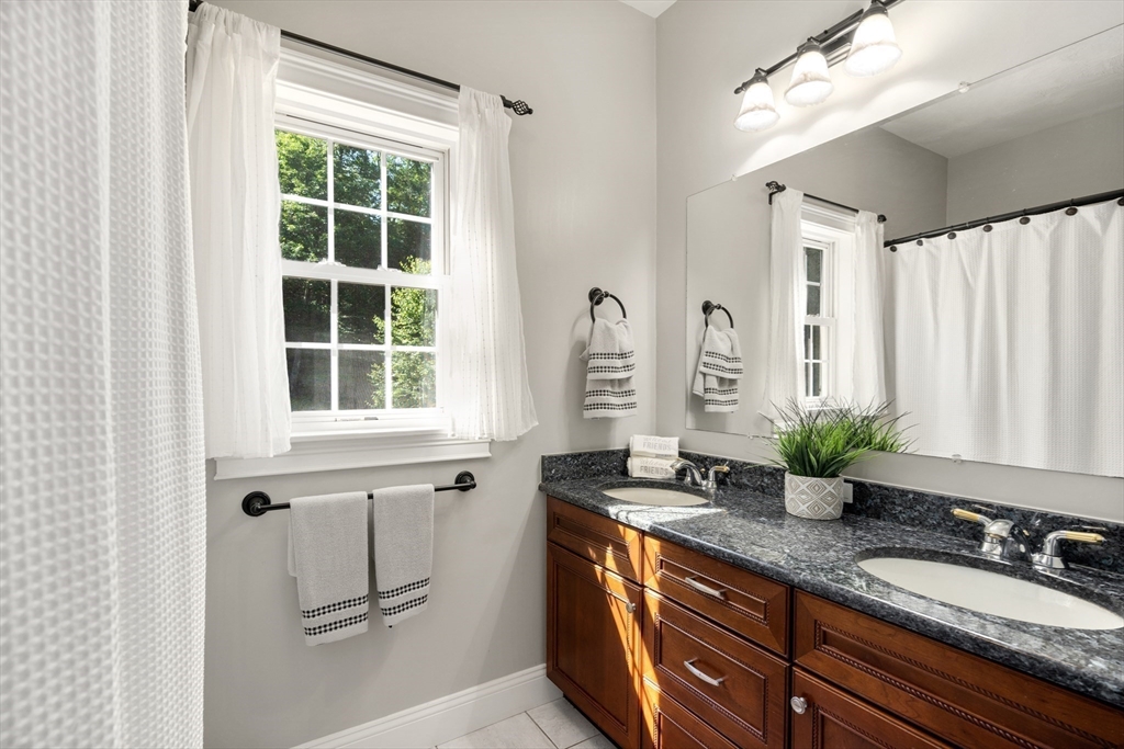 400 New Boston Road Sturbridge, MA 01566 - Photo 33 of 42 a bathroom with a granite countertop sink a mirror and a window
