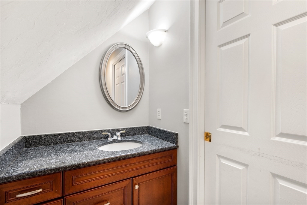 400 New Boston Road Sturbridge, MA 01566 - Photo 37 of 42 a bathroom with a granite countertop double vanity sink and a mirror