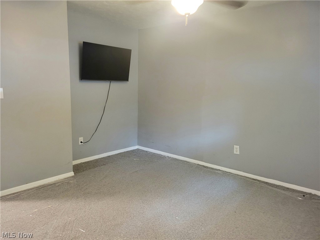 4895 Lear Nagle Road North Ridgeville, OH 44039 - Photo 18 of 27 Carpeted spare room featuring ceiling fan