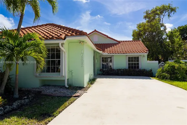 a front view of a house with plants