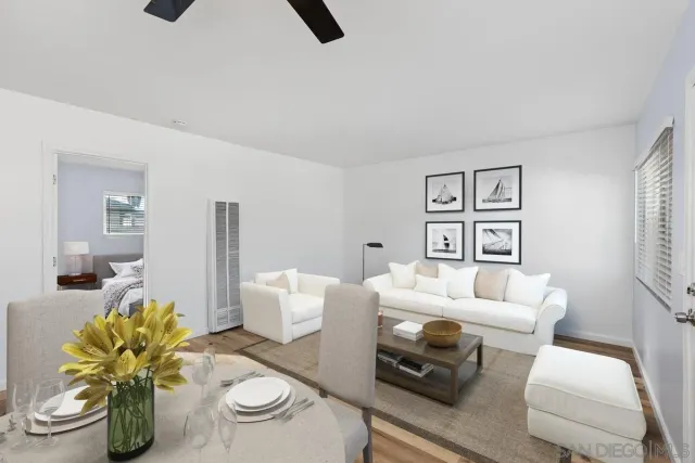 a living room with furniture and a floor to ceiling window