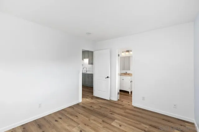 a view of an empty room and wooden floor