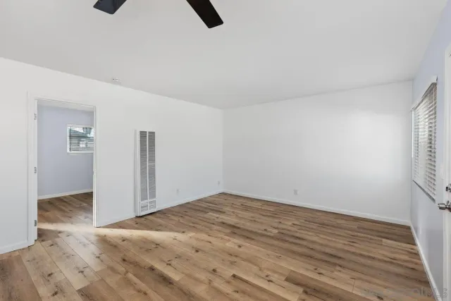 an empty room with closet and windows
