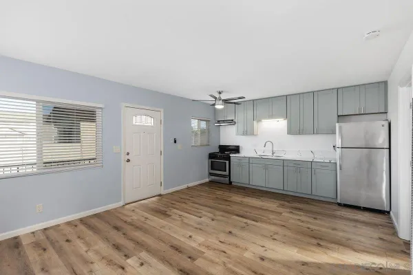 a kitchen with stainless steel appliances granite countertop a refrigerator sink and cabinets