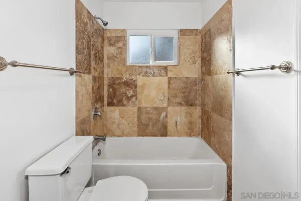 a bathroom with a toilet and a bathtub