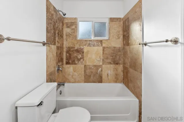 a bathroom with a toilet and a bathtub