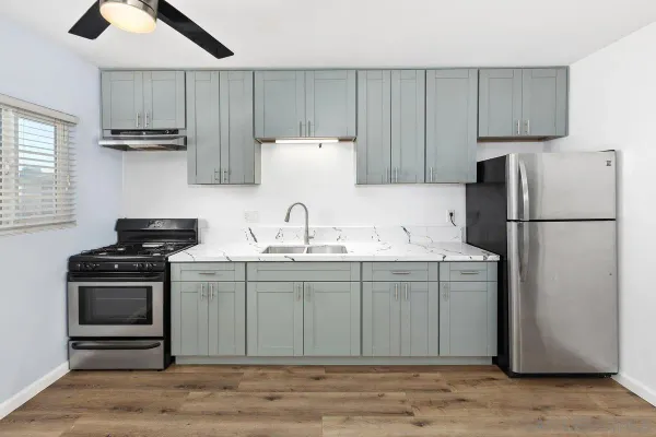 a kitchen with kitchen island a sink stainless steel appliances and cabinets