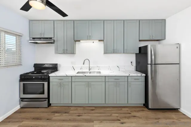 a kitchen with kitchen island a sink stainless steel appliances and cabinets