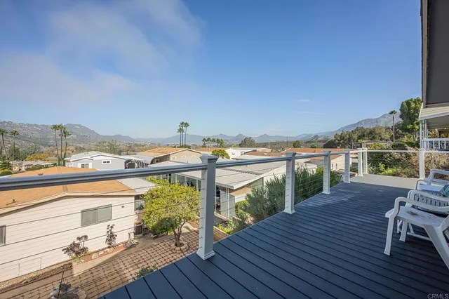 a view of roof deck with two chairs and wooden floor
