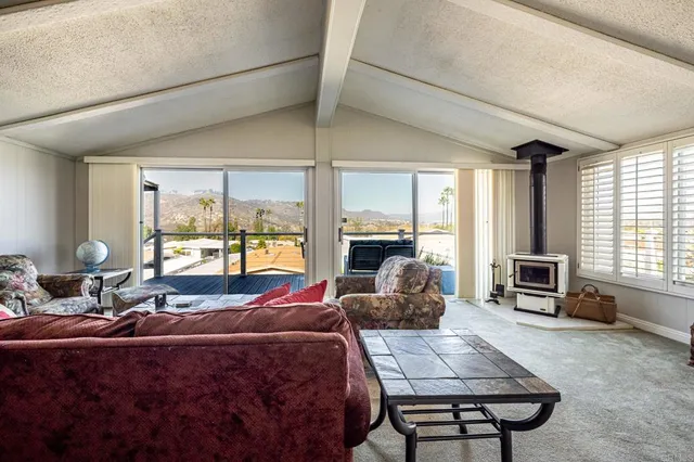 a living room with furniture large windows and a flat screen tv