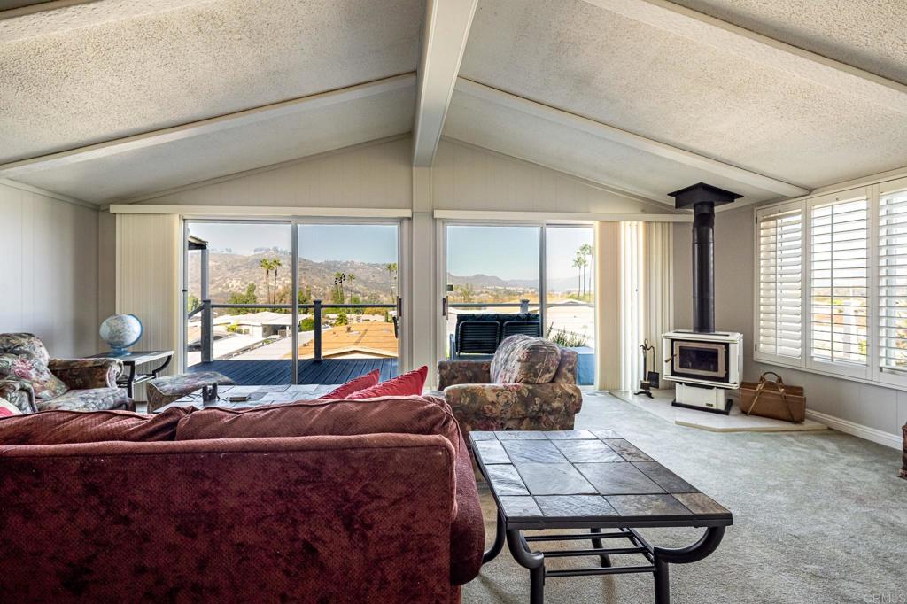4650 Dulin Road, Unit 111 Fallbrook, CA 92003 - Photo 15 of 35 a living room with furniture large windows and a flat screen tv