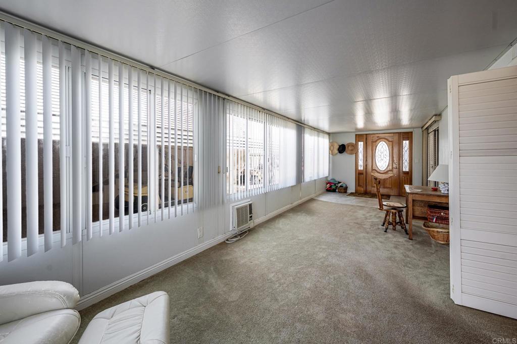 4650 Dulin Road, Unit 111 Fallbrook, CA 92003 - Photo 22 of 35 a living room with furniture and a large window