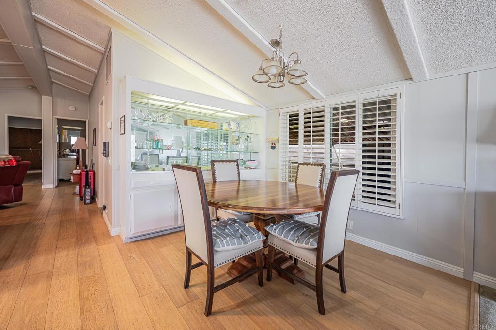 4650 Dulin Road, Unit 111 Fallbrook, CA 92003 - Photo 24 of 35 a view of a dining room with furniture wooden floor and chandelier