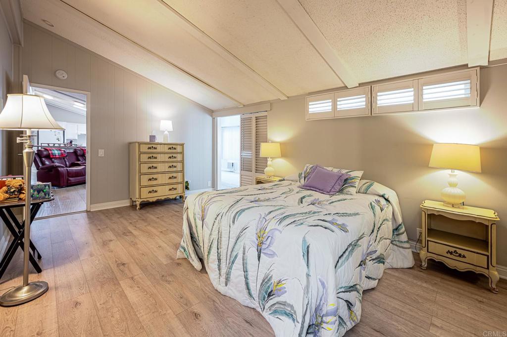 4650 Dulin Road, Unit 111 Fallbrook, CA 92003 - Photo 27 of 35 a bedroom with a bed and a chandelier