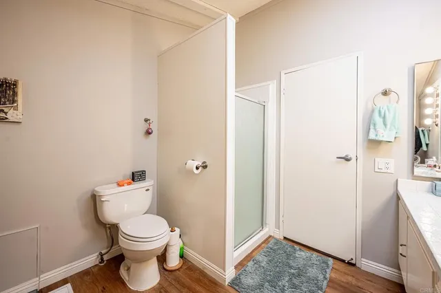 a bathroom with a toilet and a shower