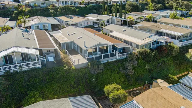 an aerial view of multiple houses with yard