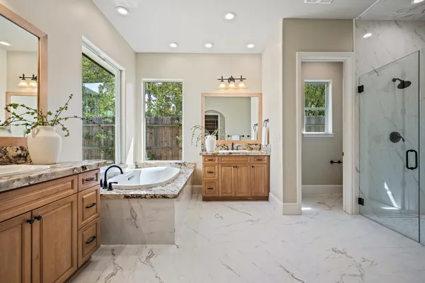 a large white kitchen with a large window
