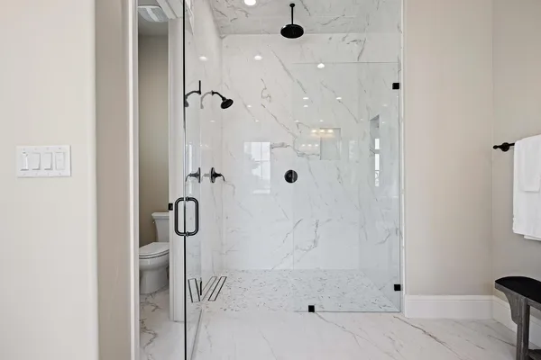a bathroom with a glass shower door