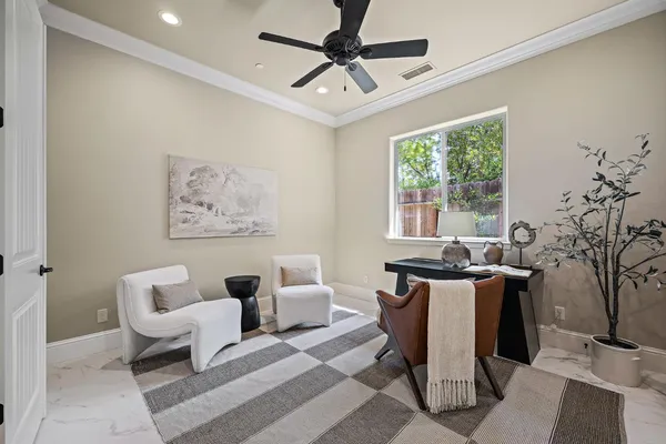 a living room with furniture a chandelier and a window