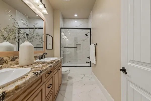 a kitchen with stainless steel appliances granite countertop a refrigerator and a stove
