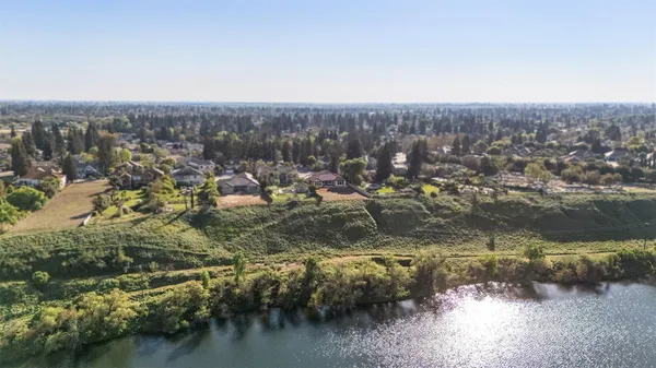 an aerial view of residential house with outdoor space and lake view