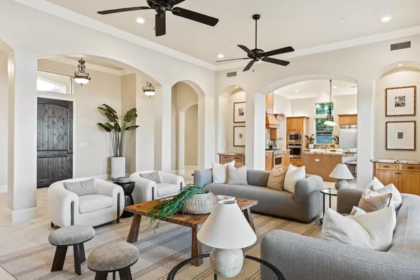 a living room with furniture and a chandelier