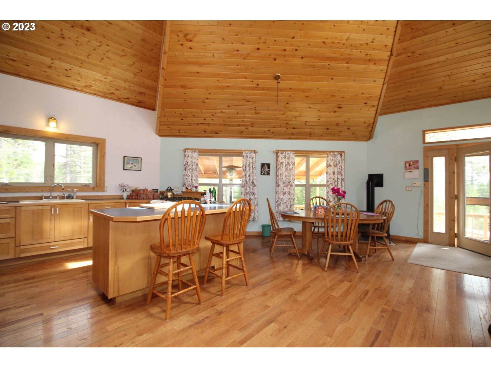 60535 Tucker Down Road Joseph, OR 97846 - Photo 13 of 37 a dining room with wooden floor a glass table and chairs