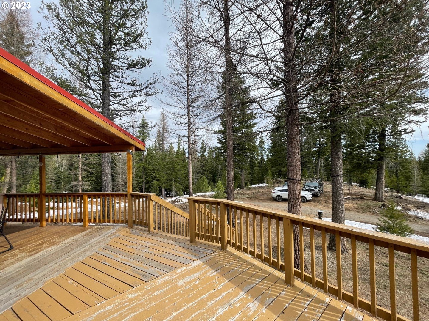 60535 Tucker Down Road Joseph, OR 97846 - Photo 2 of 37 a view of a wooden deck with chairs and large trees