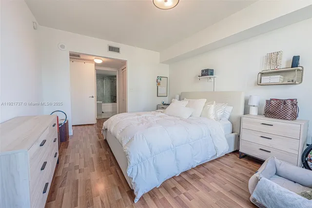 a bedroom with a bed and a dresser