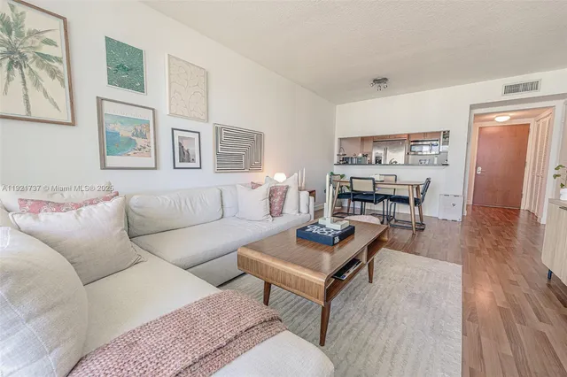 a living room with furniture wooden floor and a table