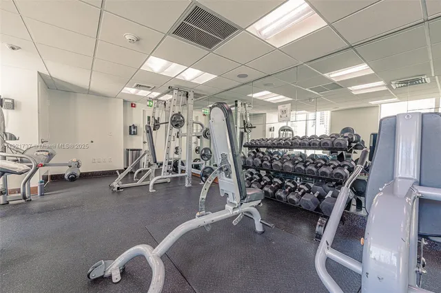 a living room with furniture and floor to ceiling windows