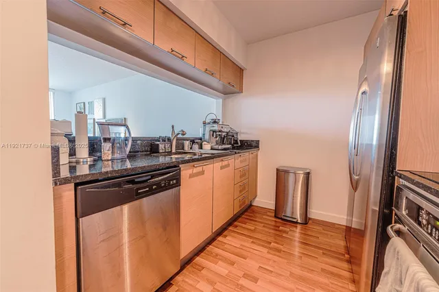a kitchen with stainless steel appliances a sink and cabinets