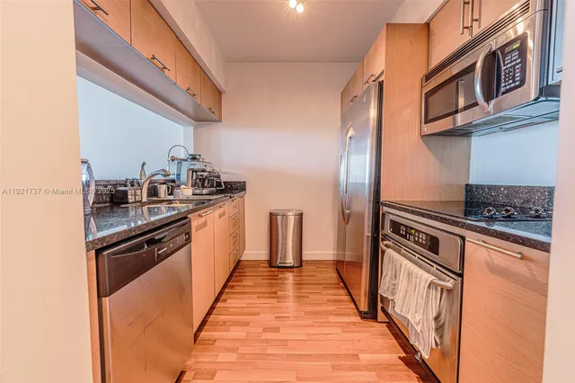 a kitchen with stainless steel appliances granite countertop a stove and a sink