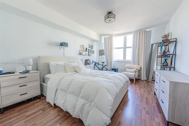 a spacious bedroom with a bed and a book shelf