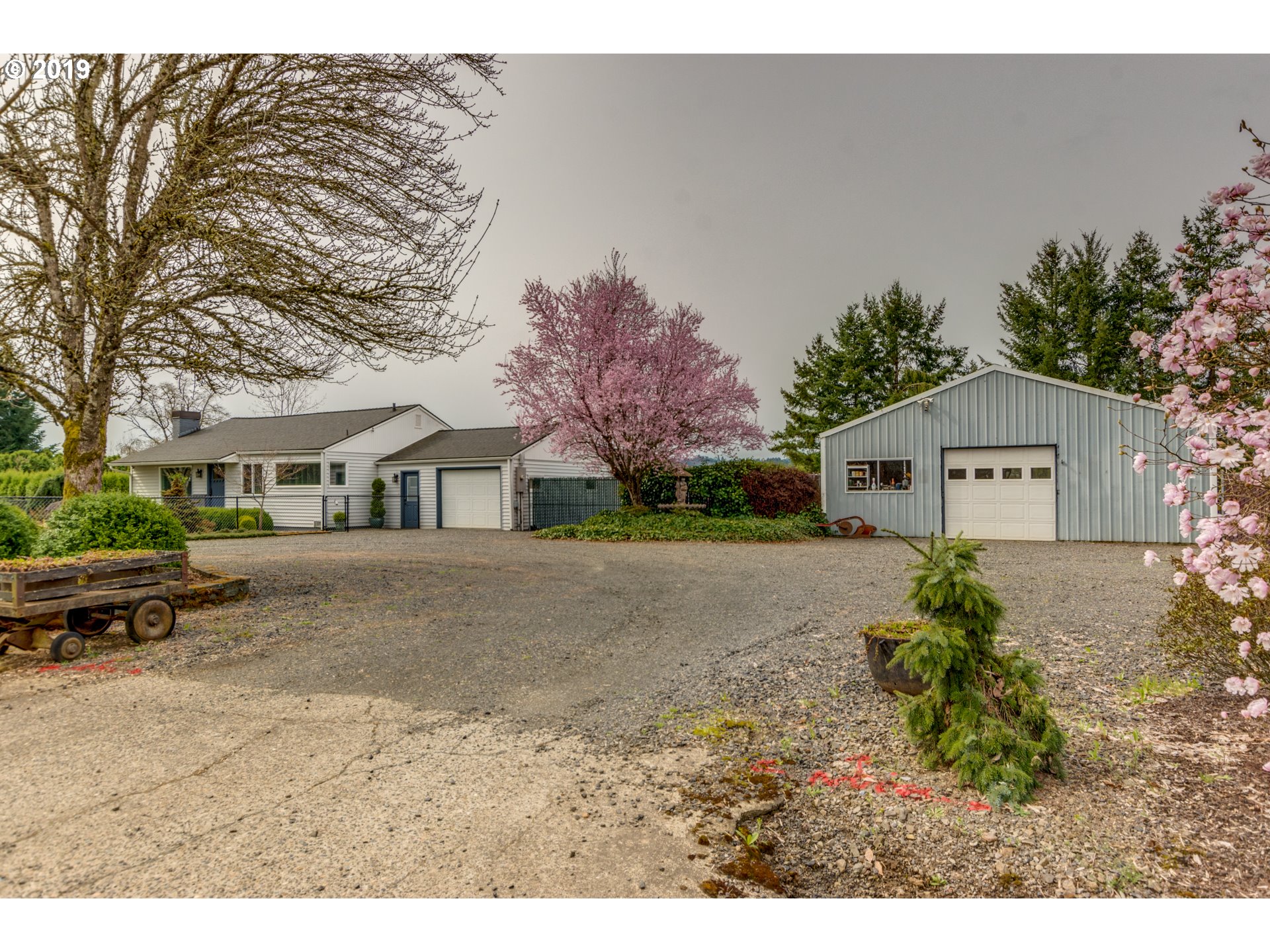 11379 Southwest Spring Hill Road Gaston, OR 97119 - Photo 1 of 28 a front view of a house with a yard and garage