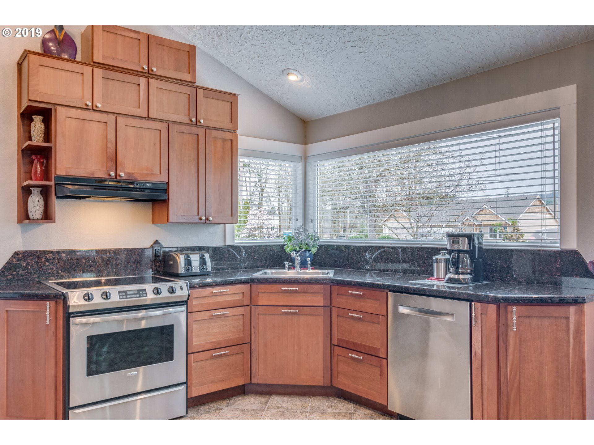 11379 Southwest Spring Hill Road Gaston, OR 97119 - Photo 11 of 28 a kitchen with granite countertop a sink a stove and cabinets