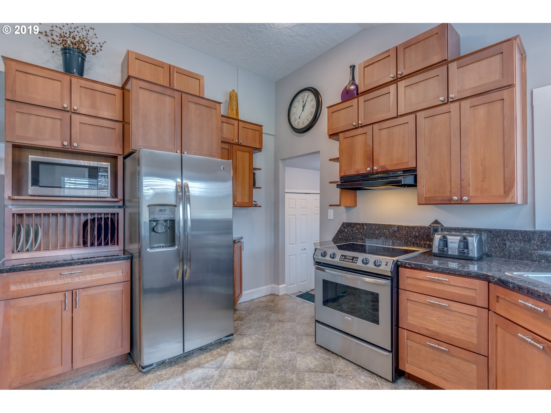 11379 Southwest Spring Hill Road Gaston, OR 97119 - Photo 12 of 28 a kitchen with stainless steel appliances granite countertop a stove a refrigerator and a cabinets