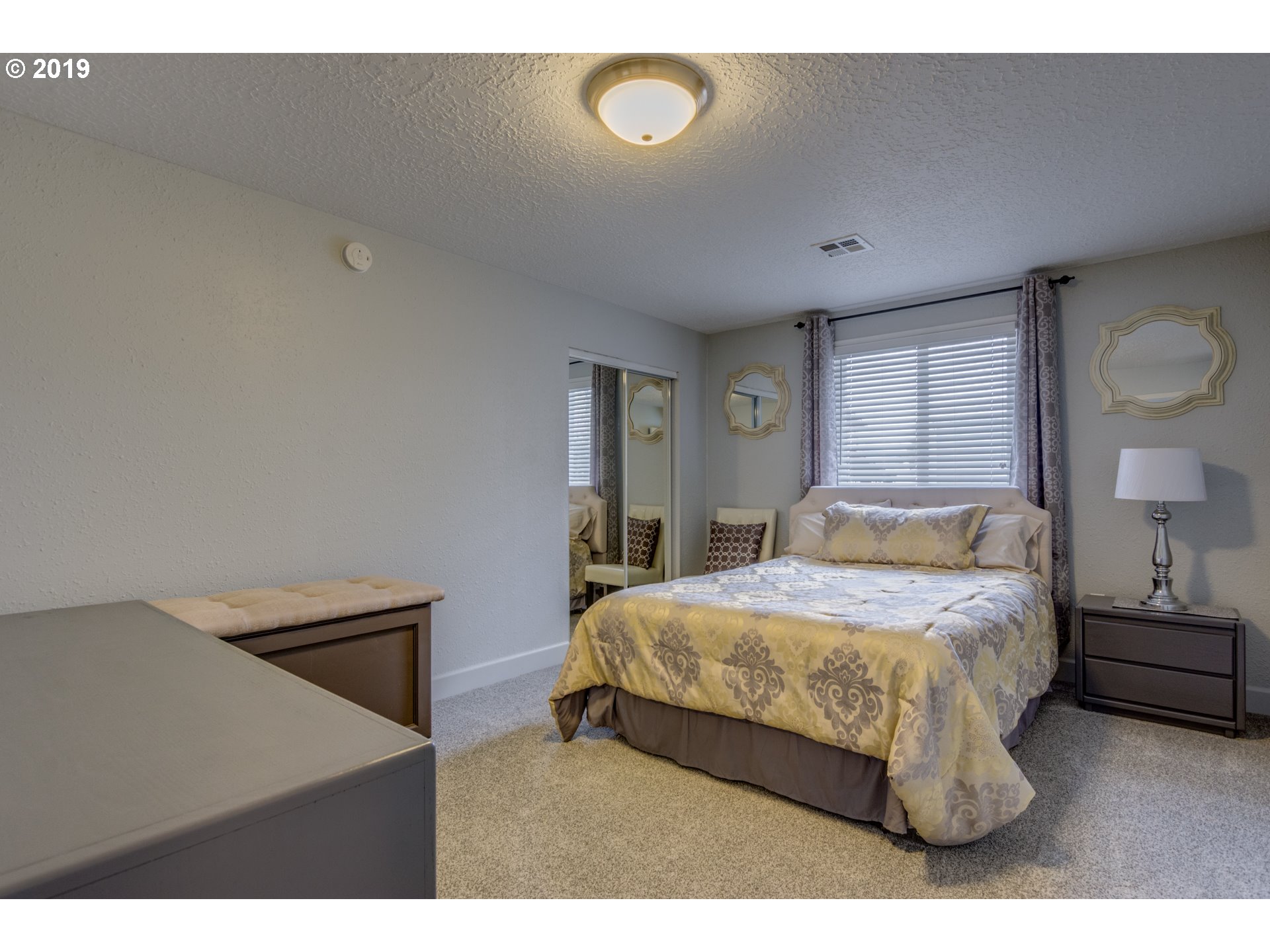 11379 Southwest Spring Hill Road Gaston, OR 97119 - Photo 16 of 28 a bedroom with a bed and a night stand
