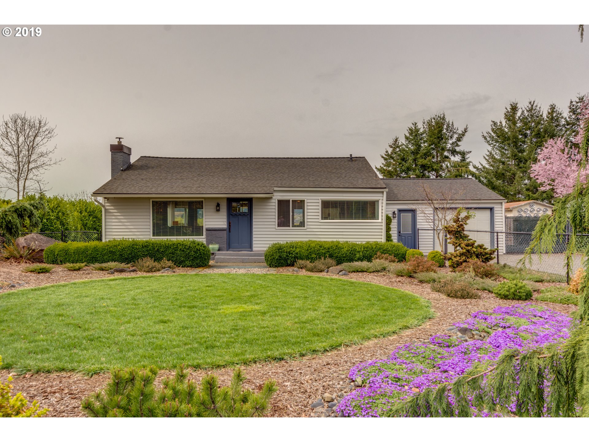 11379 Southwest Spring Hill Road Gaston, OR 97119 - Photo 2 of 28 a front view of a house with garden