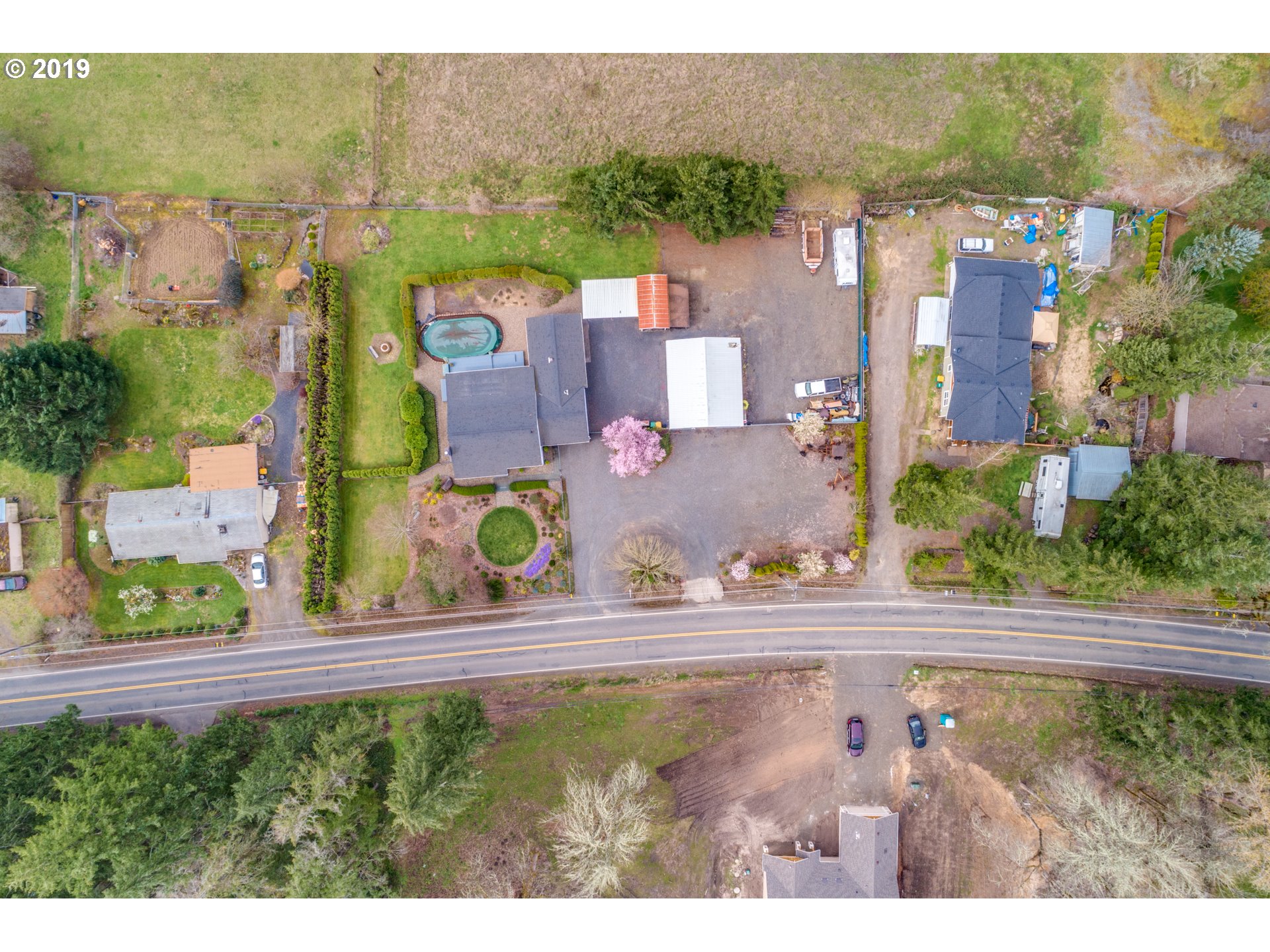 11379 Southwest Spring Hill Road Gaston, OR 97119 - Photo 28 of 28 an aerial view of residential houses with outdoor space and parking
