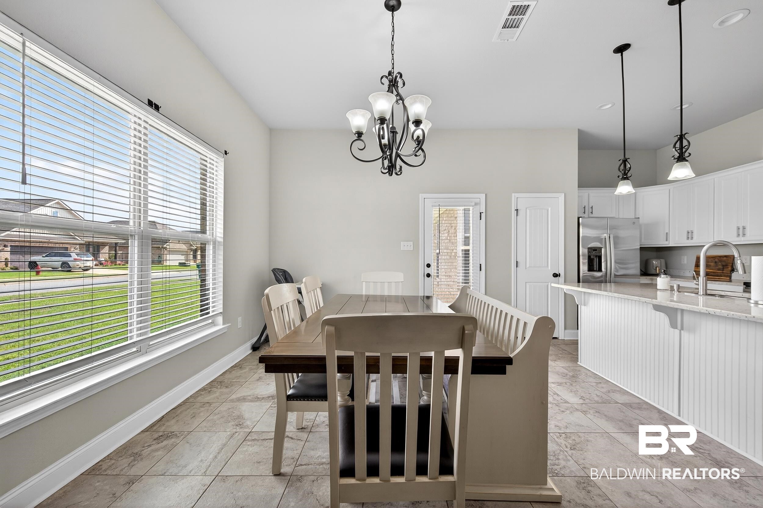 1084 Stella Road Foley, AL 36535 - Photo 9 of 31 Dining room with hanging lights and baseboards