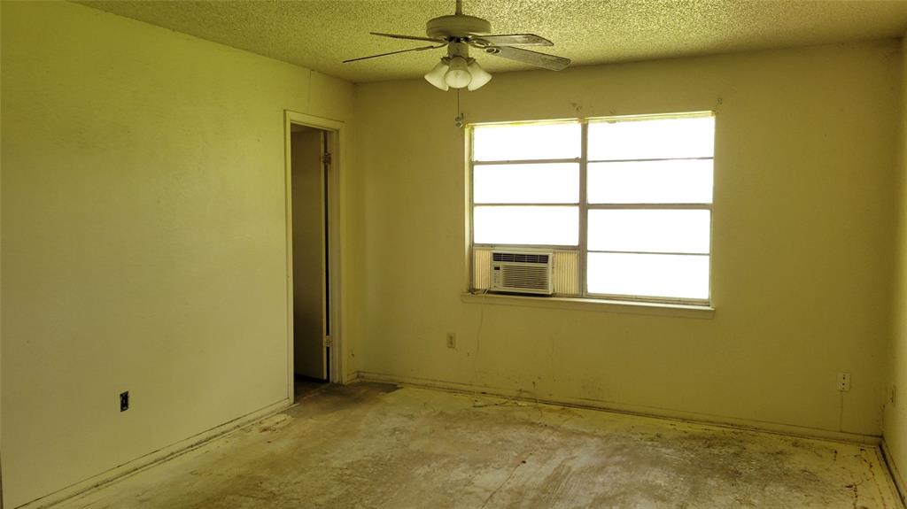902 South Old Temple Road Hewitt, TX 76643 - Photo 17 of 32 Interior room with a window-mounted air conditioning unit, ceiling fan with light fixture, and an interior doorway