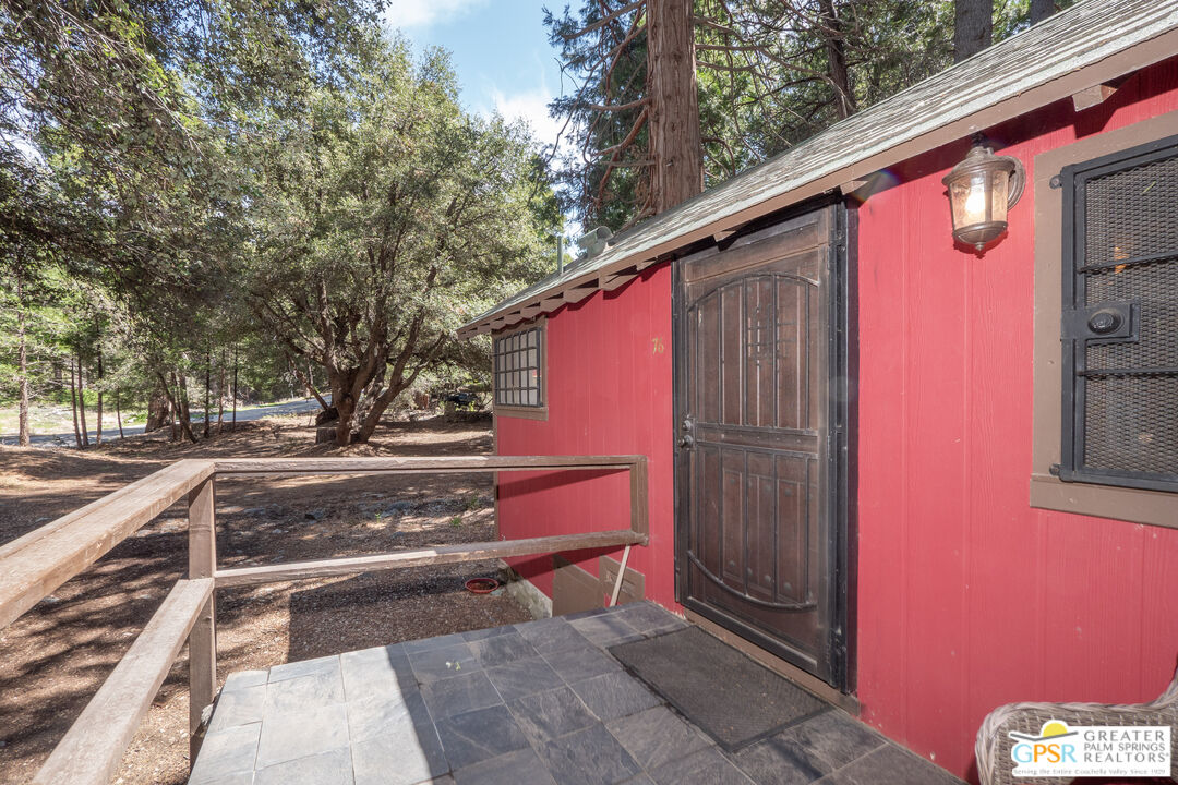 76 7 Oaks Road Angelus Oaks, CA 92305 - Photo 3 of 35 a view of backyard with a red chair and potted plants
