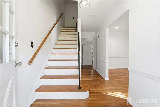 a view of entryway and hall with wooden floor
