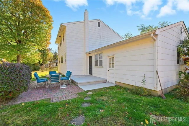 a view of a backyard with table and chairs and a fire pit