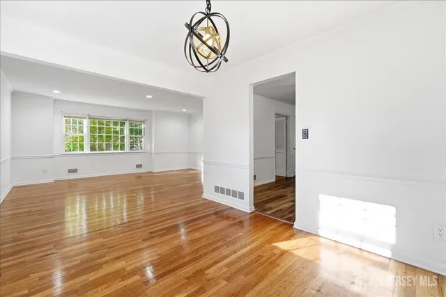 a view of a room with wooden floor and a window