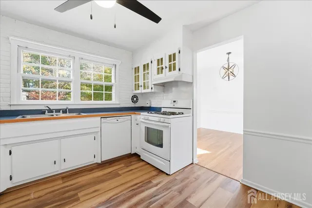 a kitchen with stainless steel appliances white cabinets and a sink