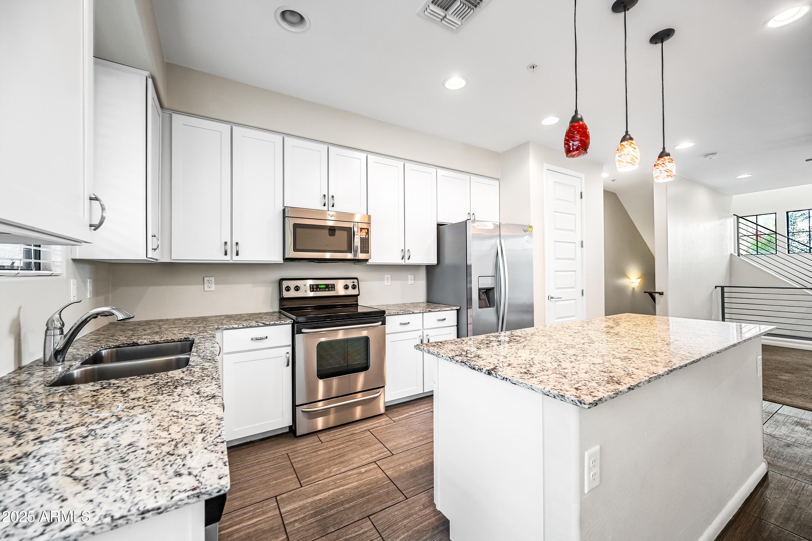 2090 South Dorsey Lane, Unit 1004 Tempe, AZ 85282 - Photo 11 of 31 a kitchen with stainless steel appliances granite countertop a sink a stove and a refrigerator